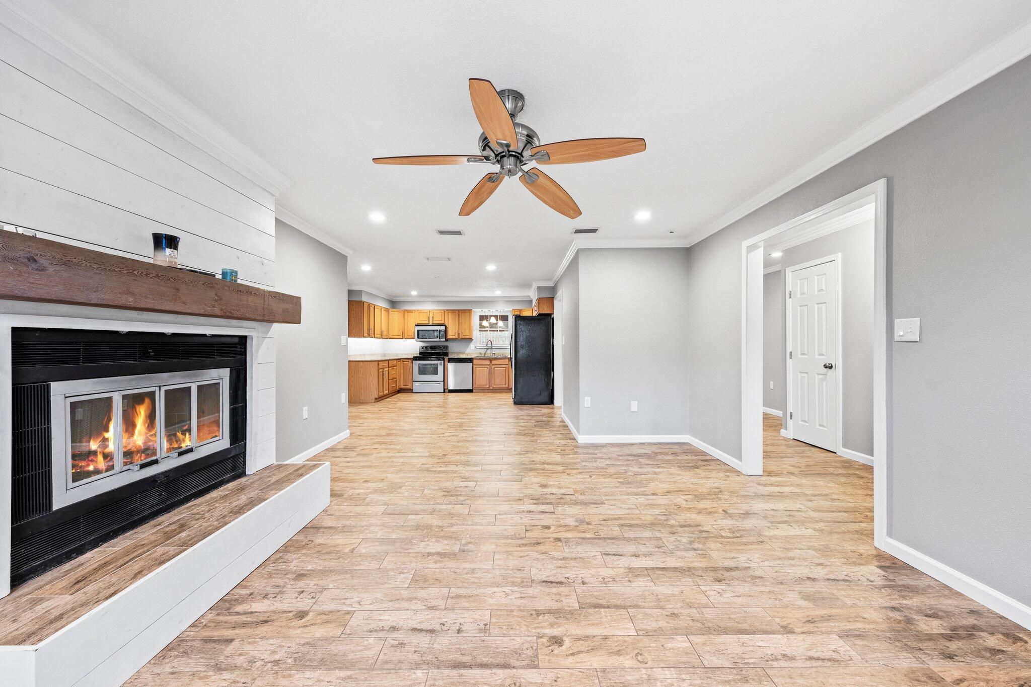 226 Terri Cove Niceville, FL 32578 - Photo 12 of 42 a view of a livingroom with a fireplace a ceiling fan and wooden floor
