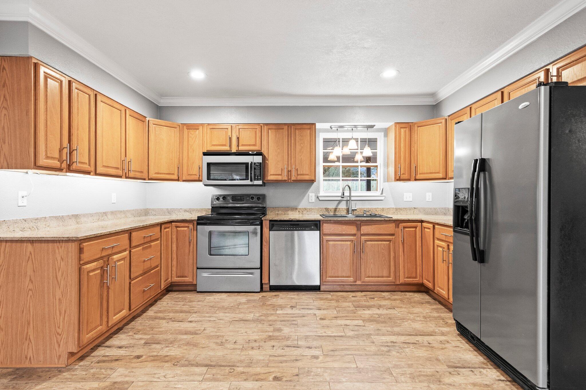 226 Terri Cove Niceville, FL 32578 - Photo 14 of 42 a kitchen with stainless steel appliances granite countertop a refrigerator stove microwave and sink