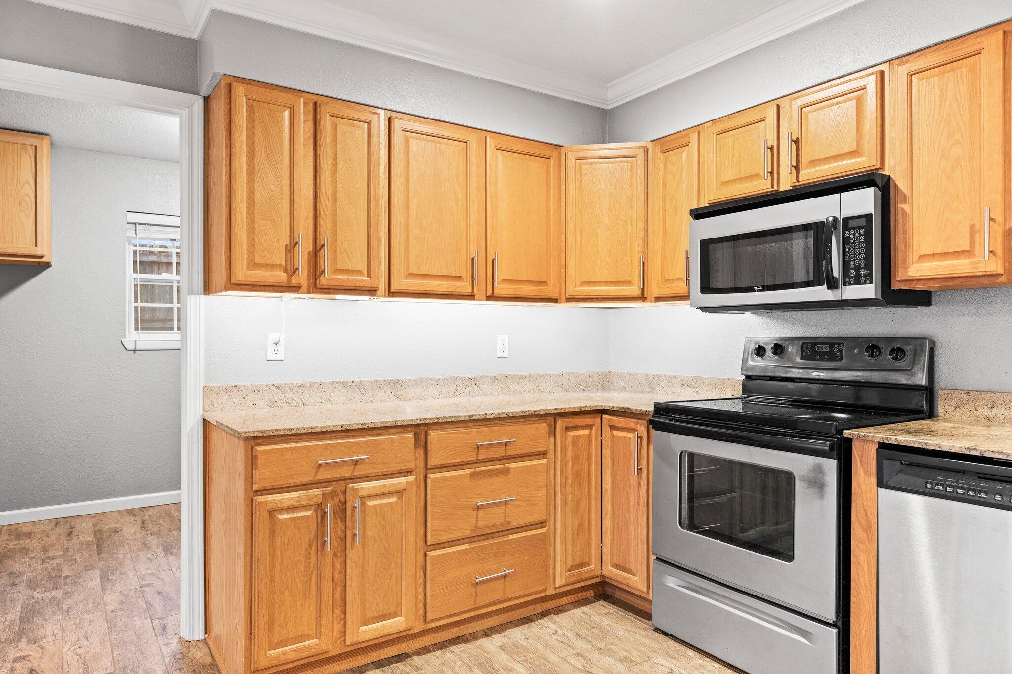 226 Terri Cove Niceville, FL 32578 - Photo 16 of 42 a kitchen with granite countertop cabinets stainless steel appliances and a window