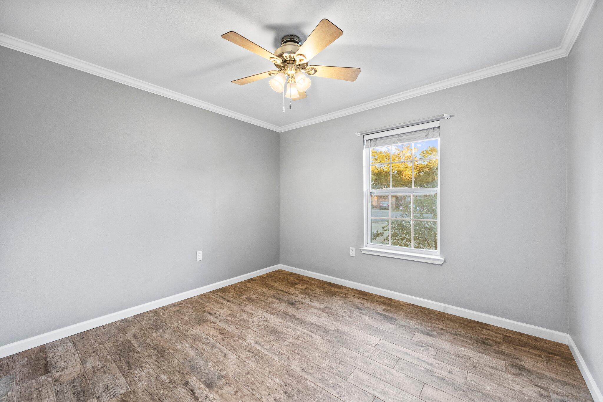 226 Terri Cove Niceville, FL 32578 - Photo 24 of 42 an empty room with a chandelier fan and windows