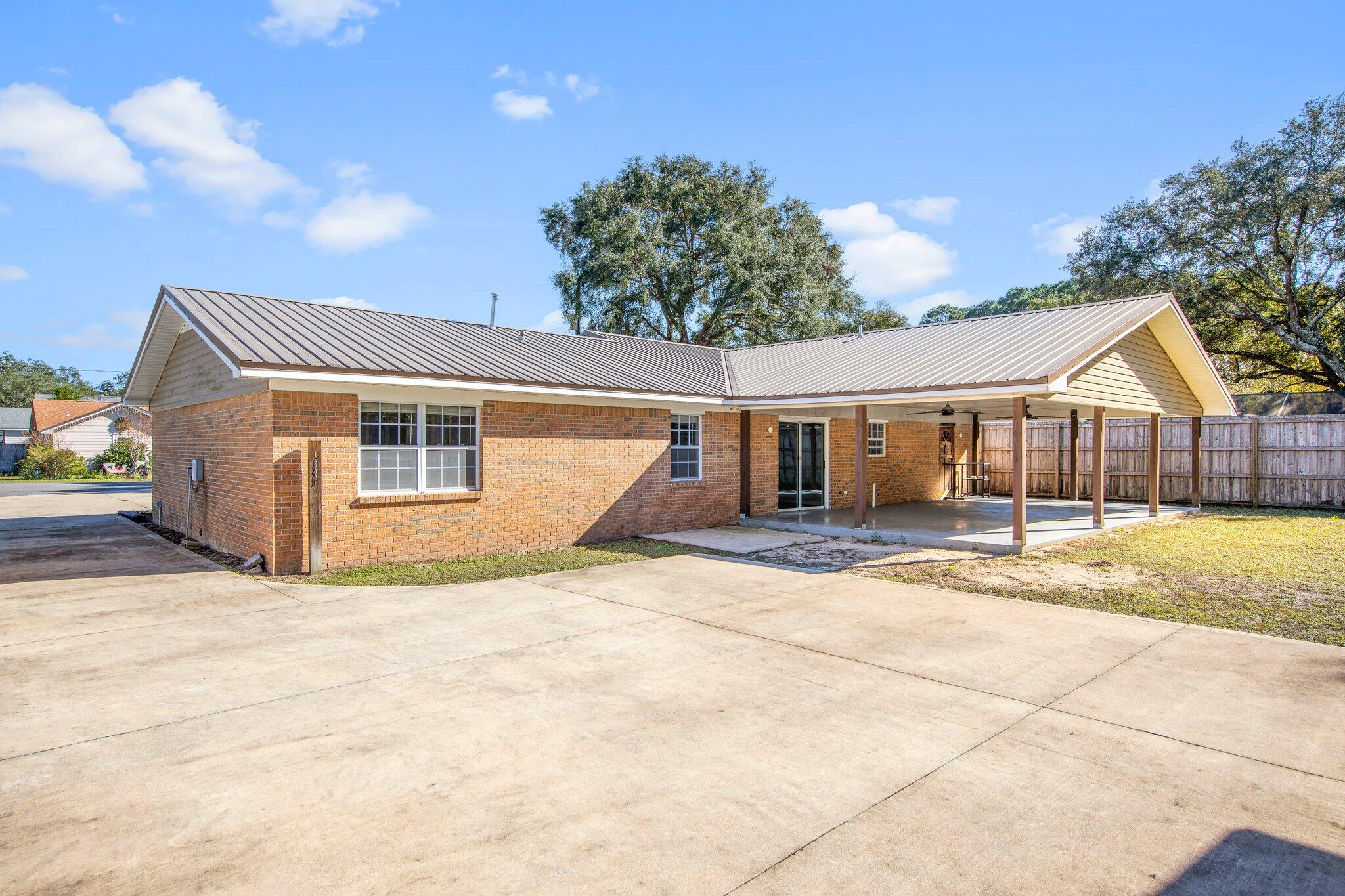 226 Terri Cove Niceville, FL 32578 - Photo 35 of 42 a view of a house with a yard and garage