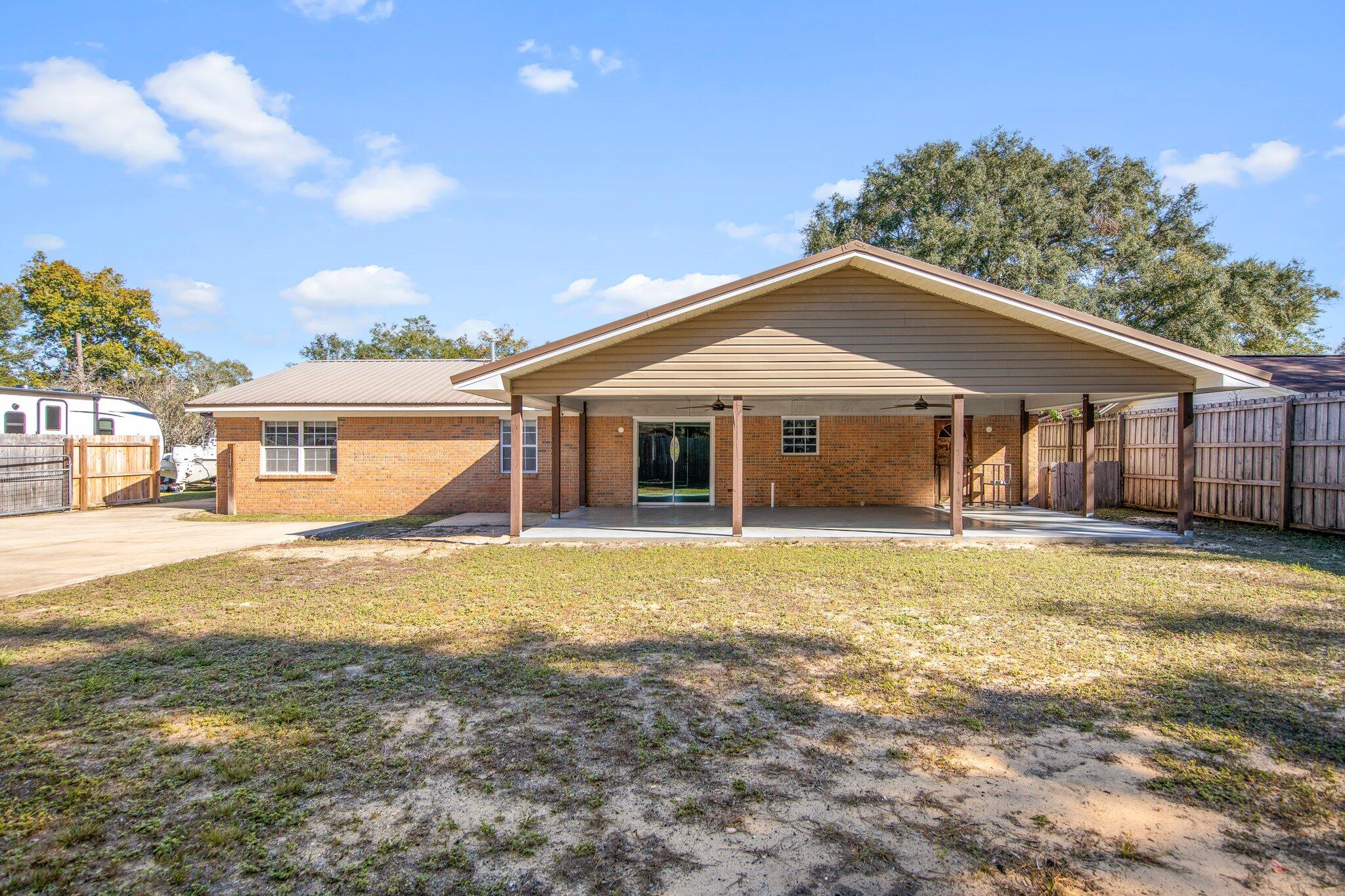 226 Terri Cove Niceville, FL 32578 - Photo 36 of 42 a front view of a house with a garden and yard