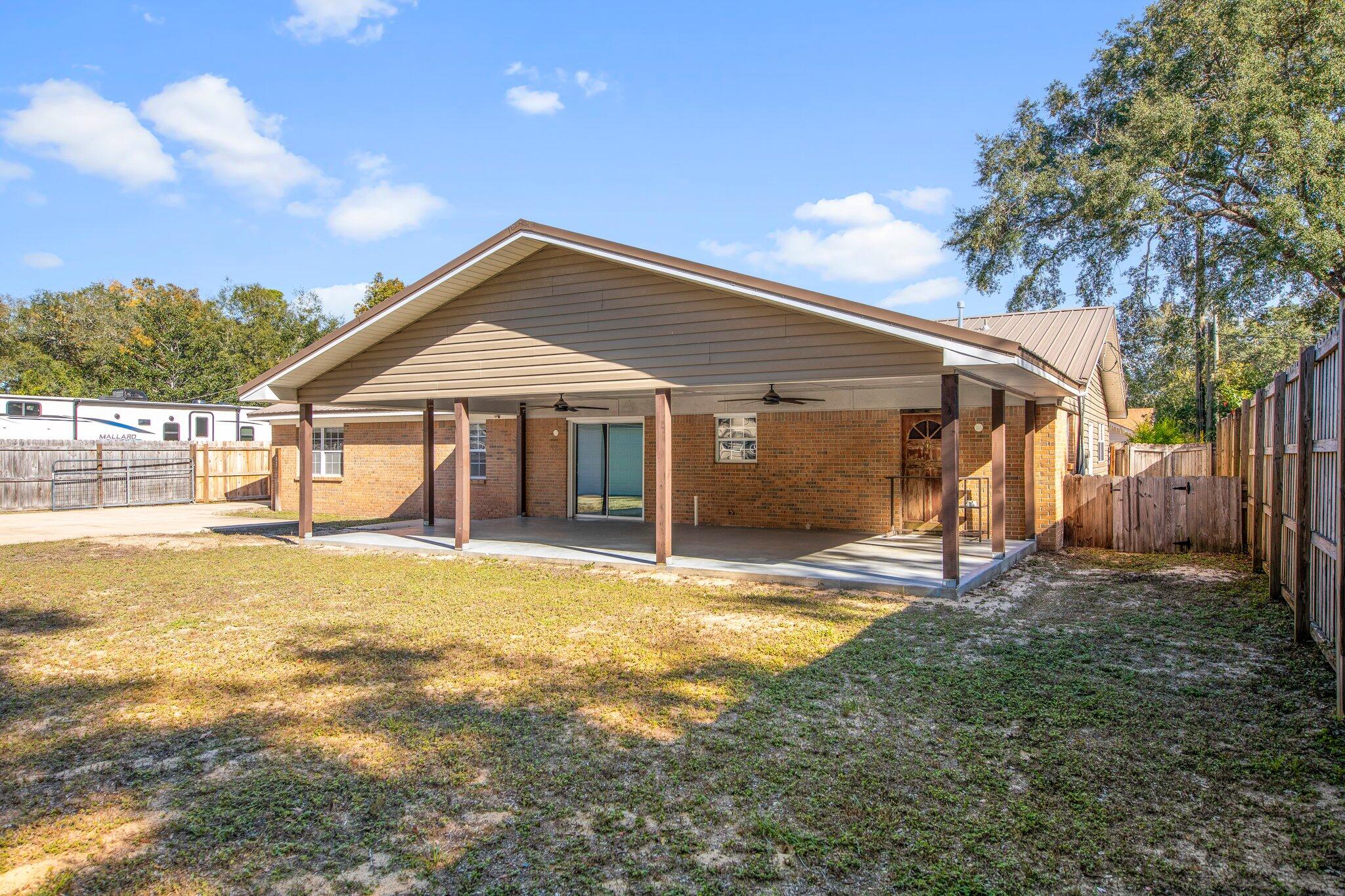 226 Terri Cove Niceville, FL 32578 - Photo 37 of 42 a front view of a house with a yard and porch