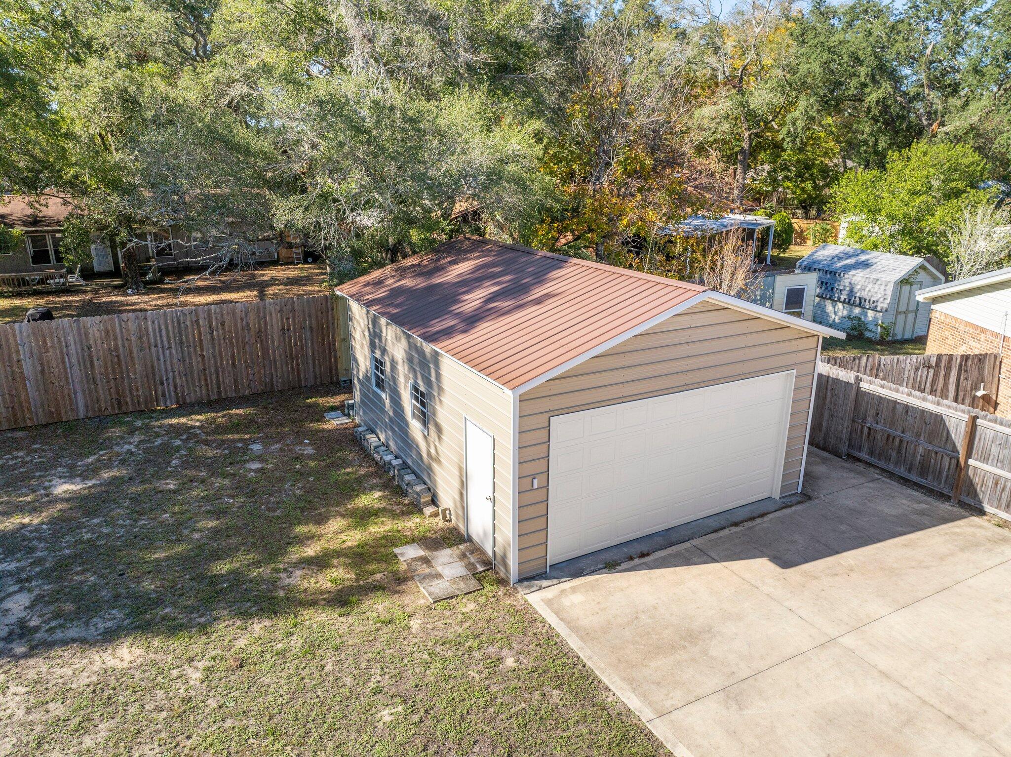 226 Terri Cove Niceville, FL 32578 - Photo 38 of 42 a view of a backyard with trees and wooden fence