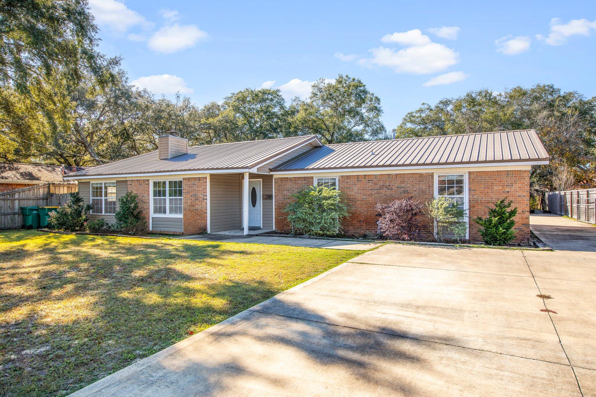 226 Terri Cove Niceville, FL 32578 - Photo 4 of 42 a view of a white house with a swimming pool and outdoor space