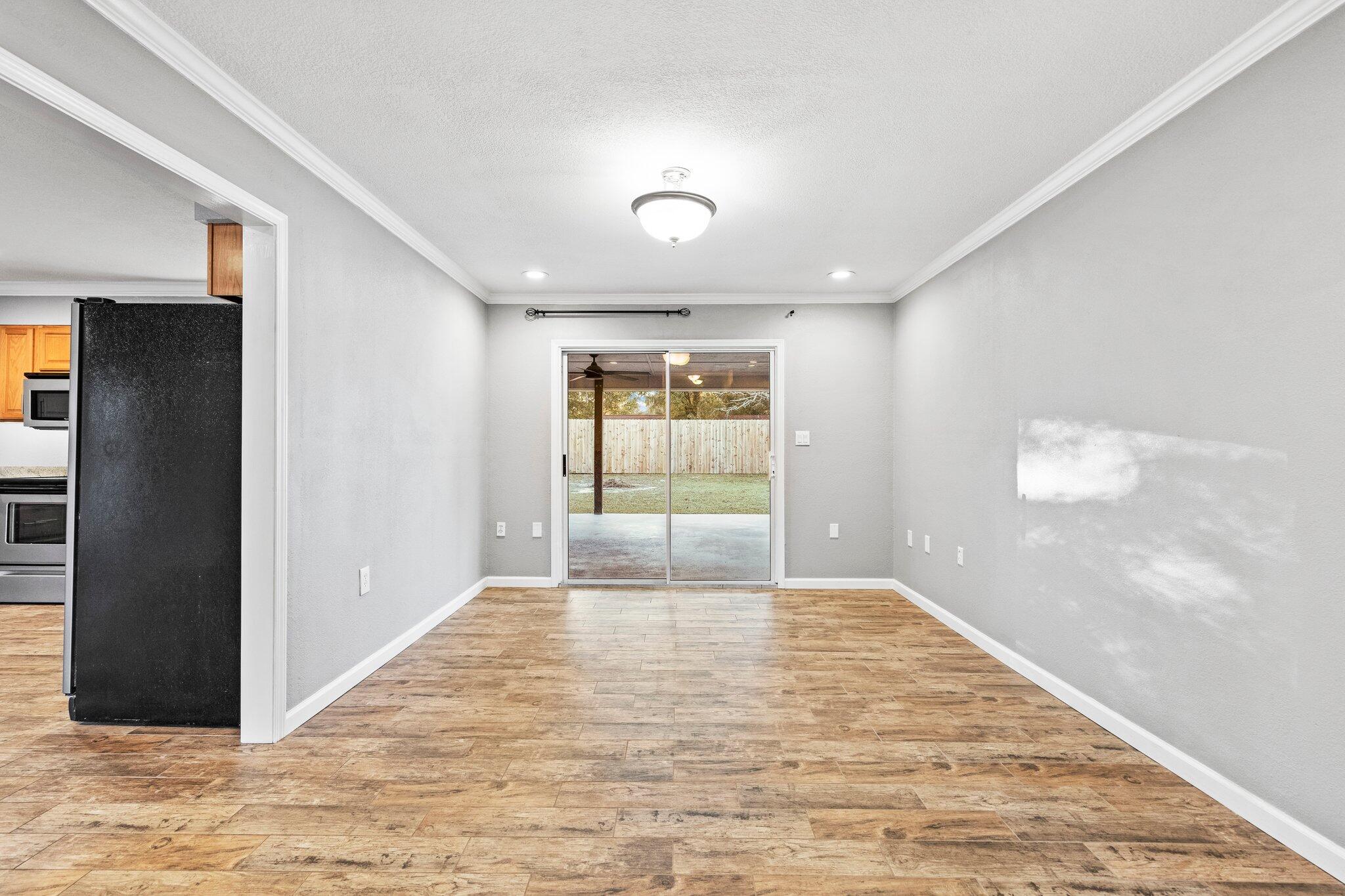 226 Terri Cove Niceville, FL 32578 - Photo 8 of 42 a view of a hallway with wooden floor and a living room
