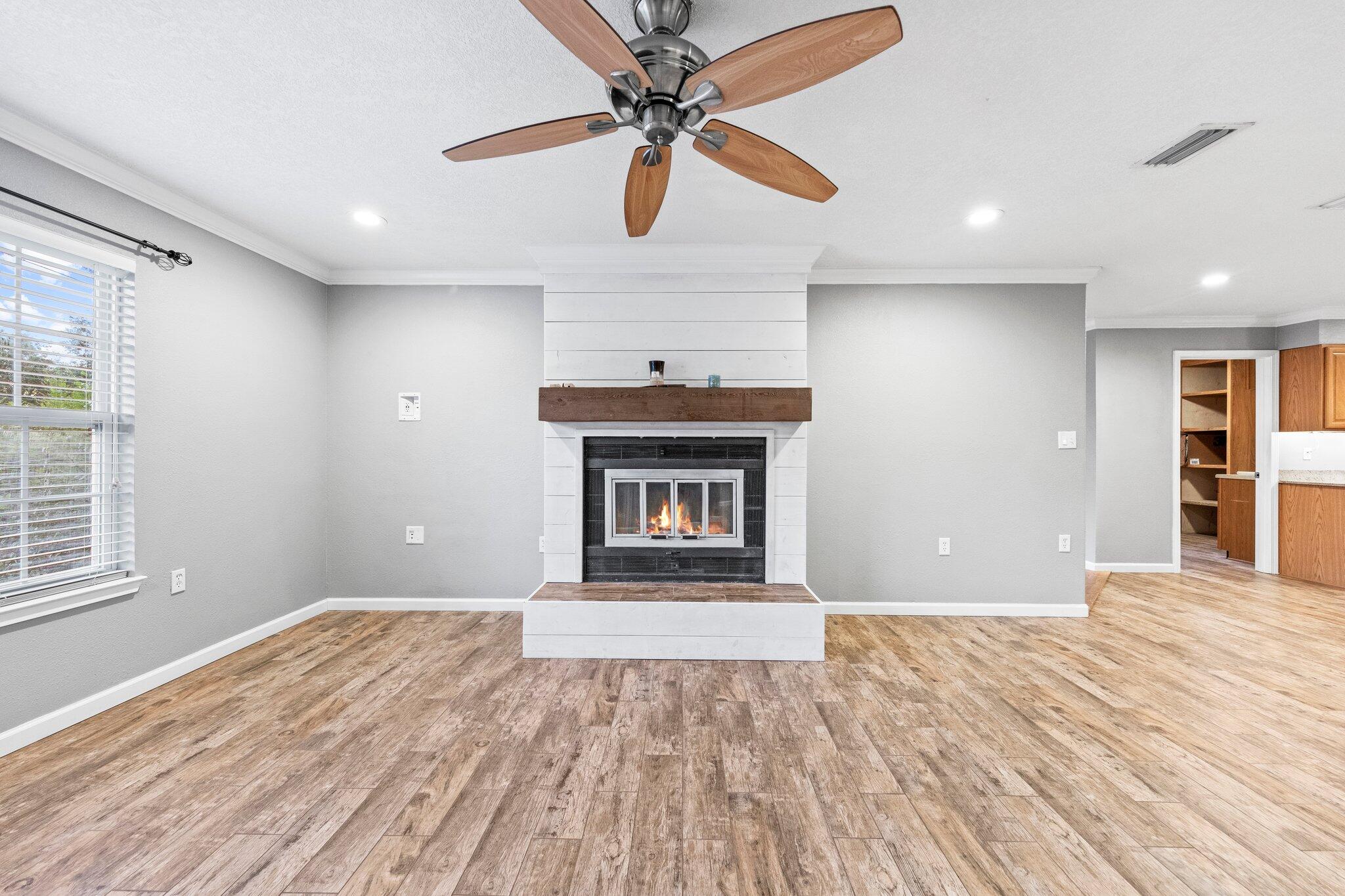 226 Terri Cove Niceville, FL 32578 - Photo 10 of 42 a view of an empty room with a fireplace and a window