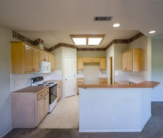 a kitchen with stainless steel appliances granite countertop a sink and cabinets