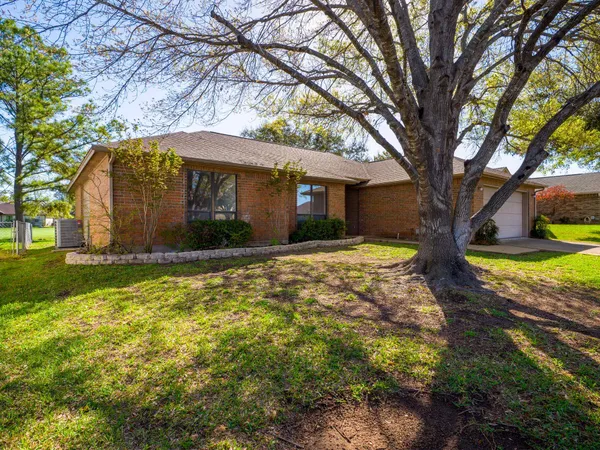 a view of a house with a large tree