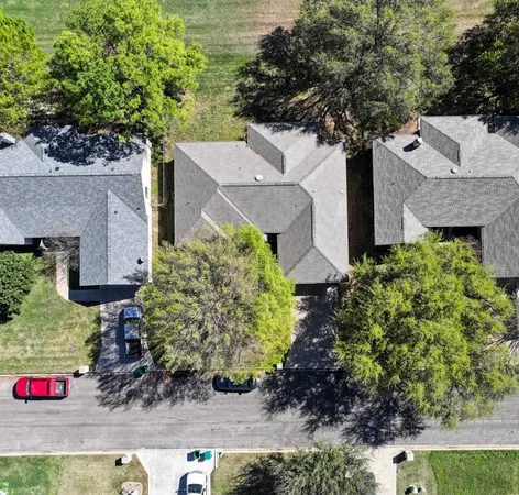 an aerial view of a house with a yard