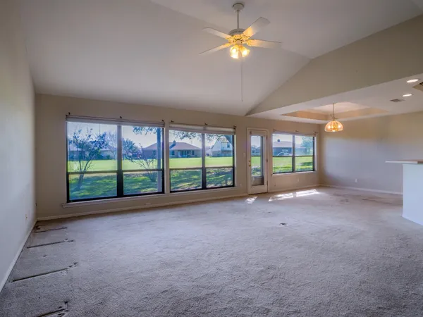 a view of a big room with windows and brick walls