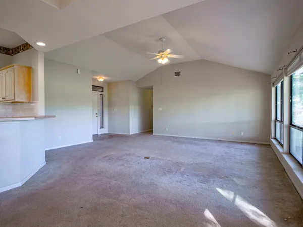a large kitchen with stainless steel appliances a large counter top a stove a chimney a sink and cabinets