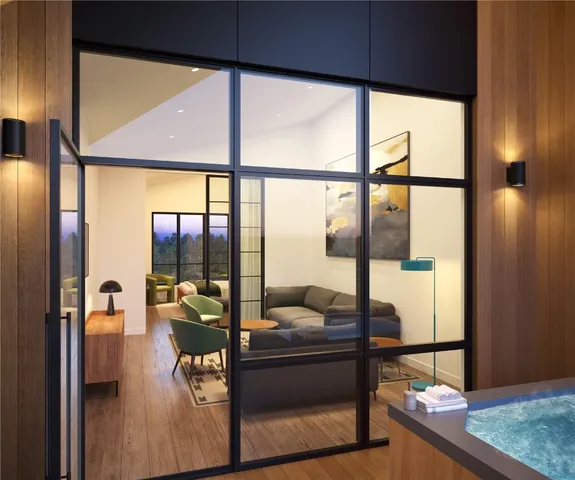 a living room with a floor to ceiling window and wooden floor