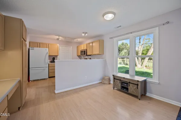 a kitchen with cabinets stainless steel appliances and a sink