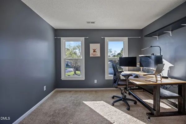 a living room with furniture a window and gym equipment