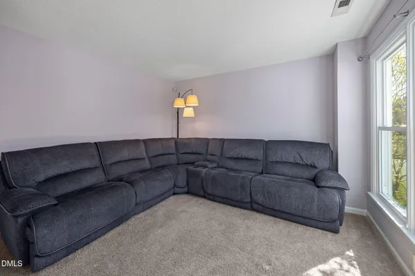a view of a dining room with furniture and a window
