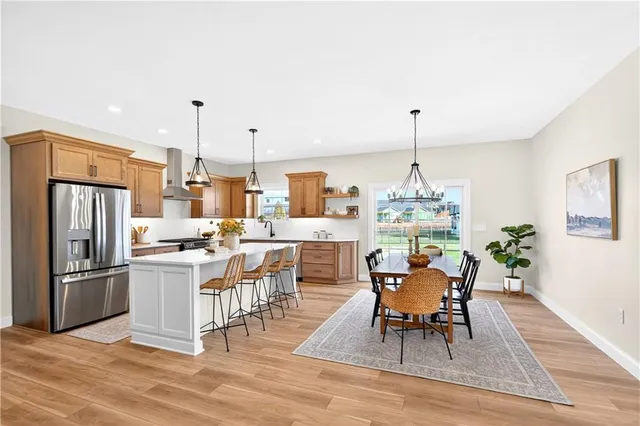 a dining room with furniture a chandelier and wooden floor