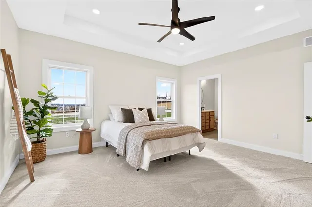 a spacious bedroom with a bed and a potted plant