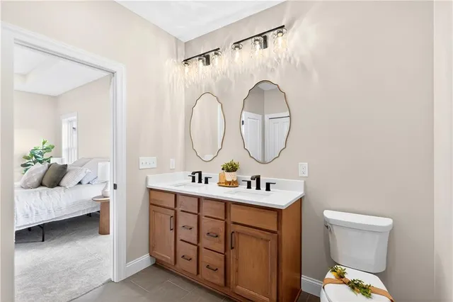 a bathroom with a toilet a sink and a mirror