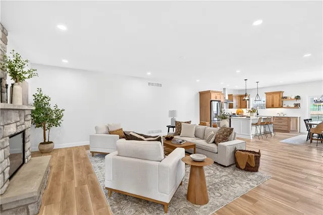 a living room with furniture and a table with wooden floor