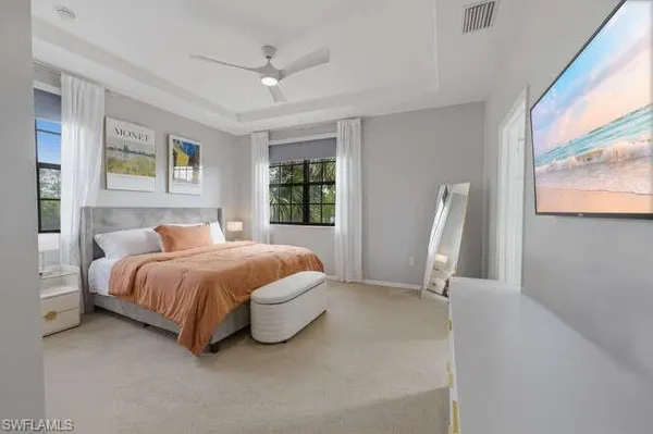 a spacious bedroom with a bed and a window