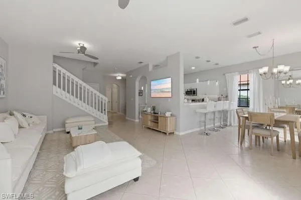 a living room with furniture and kitchen view