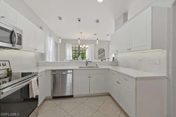 a kitchen with sink cabinets and window