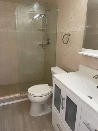 a kitchen with stainless steel appliances white cabinets and stove
