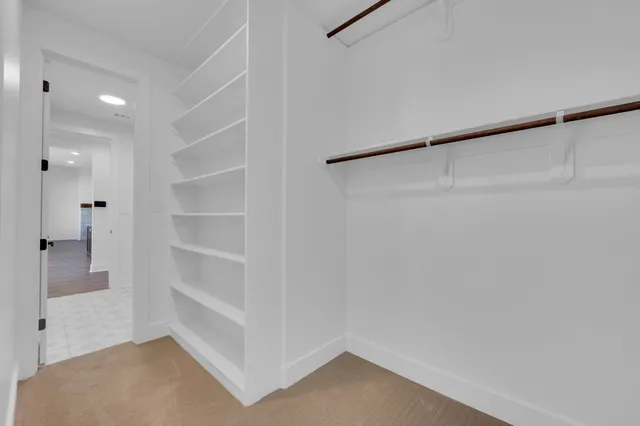 a view of a walk in closet and entryway