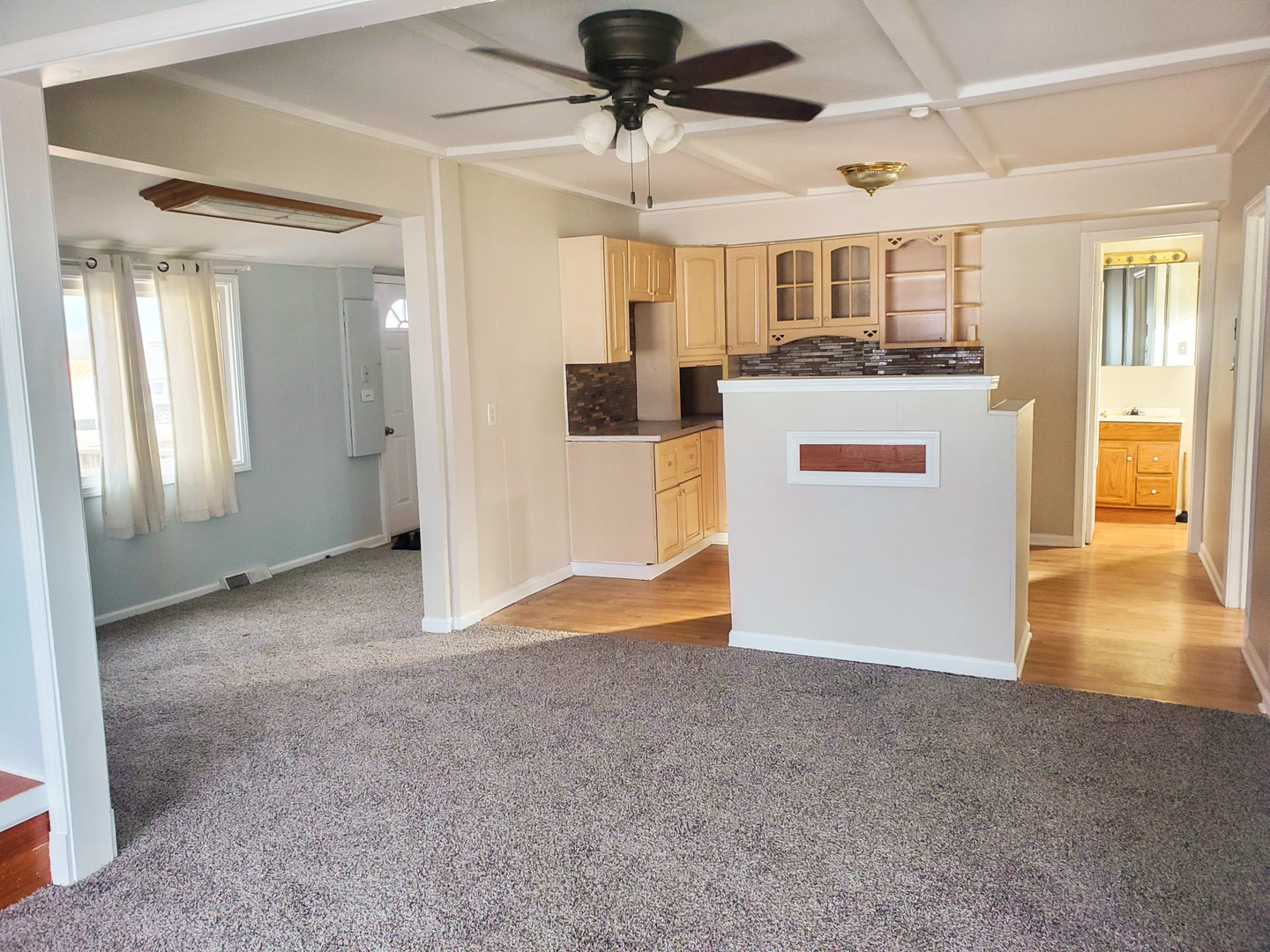 185 Eagle Point Road Fox Lake, IL 60020 - Photo 12 of 42 a view of a living room a ceiling fan and kitchen view