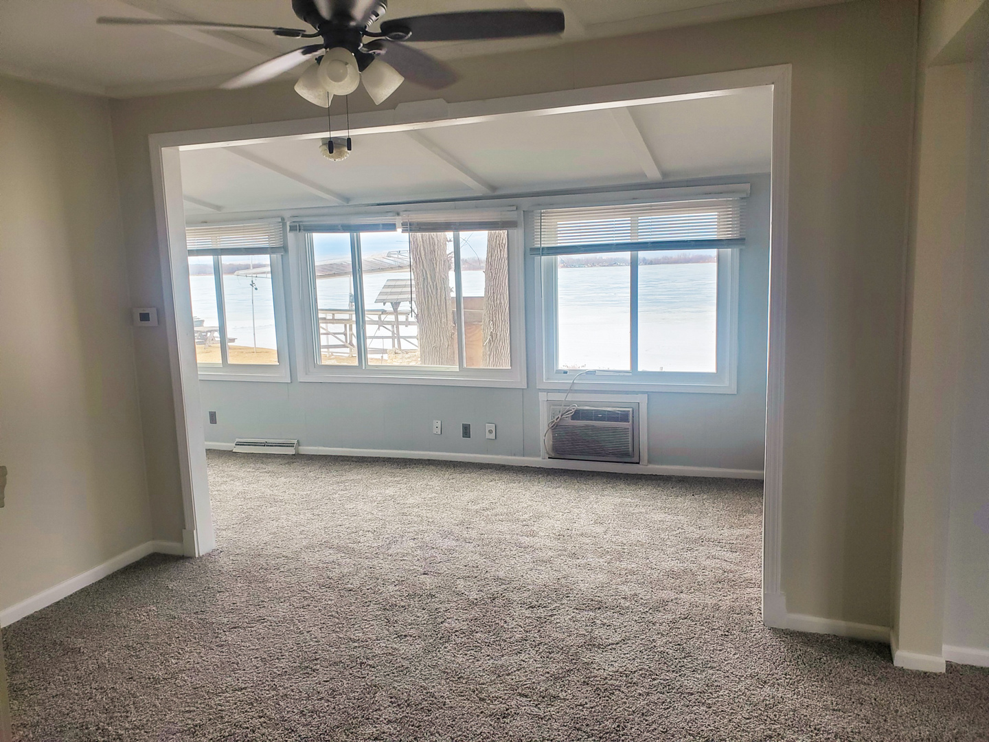 185 Eagle Point Road Fox Lake, IL 60020 - Photo 20 of 42 an empty room with chandelier fan and windows
