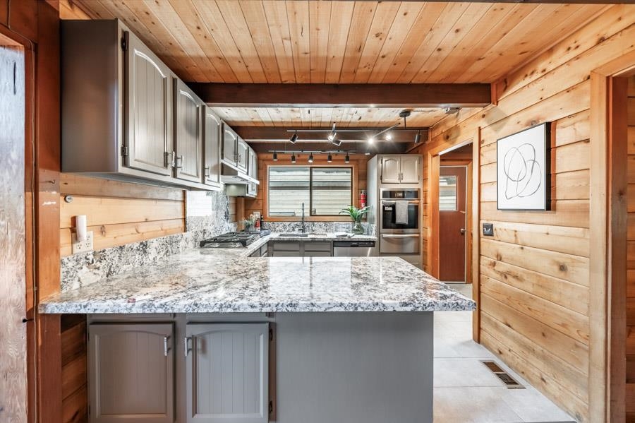 a kitchen with granite countertop a sink and cabinets