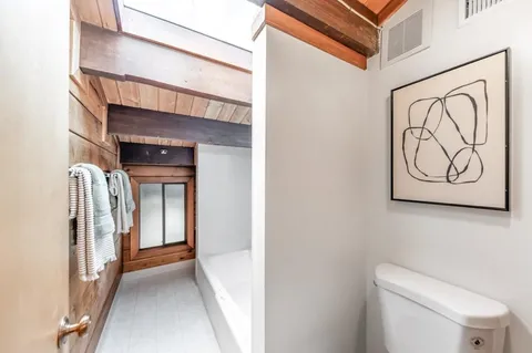 a view of a hallway with paintings on the wall