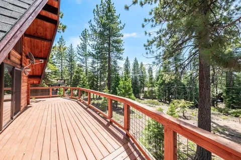 a view of balcony with wooden floor and fence