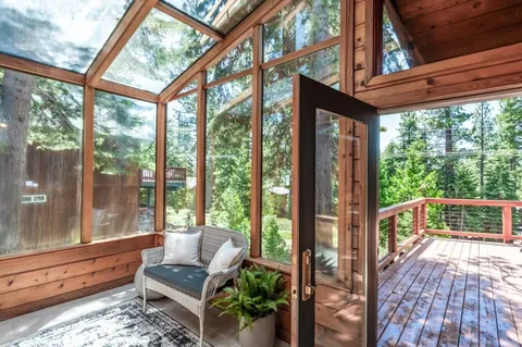 a living room with furniture and a floor to ceiling window