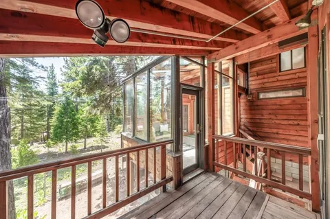 a view of a porch with wooden floor and a swing