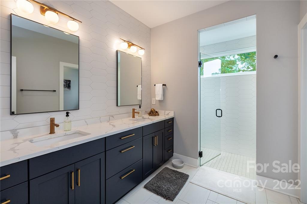 1505 Parson Street Charlotte, NC 28205 - Photo 29 of 48 a bathroom with a double vanity sink mirror and shower