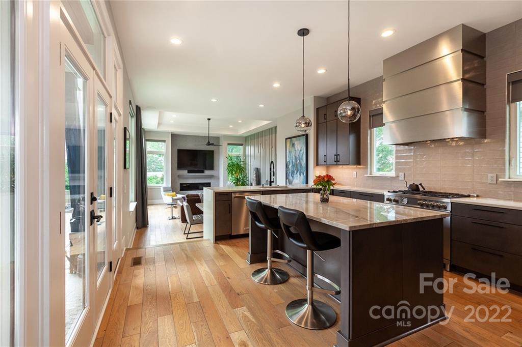 1505 Parson Street Charlotte, NC 28205 - Photo 3 of 48 a kitchen with stainless steel appliances granite countertop a sink a stove and a refrigerator
