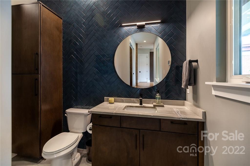 1505 Parson Street Charlotte, NC 28205 - Photo 39 of 48 a bathroom with a toilet sink vanity and mirror