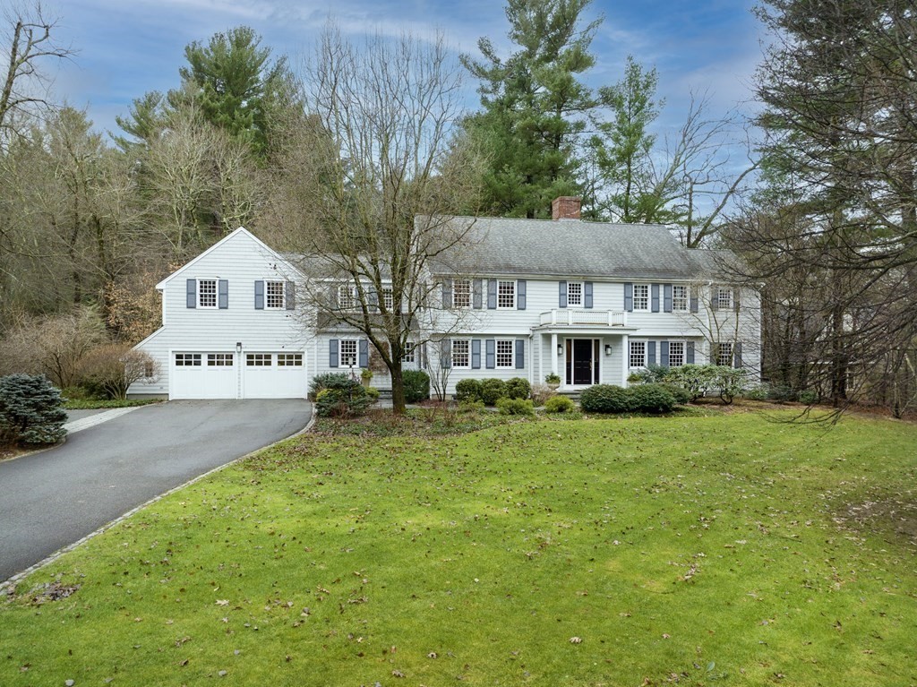 52 Ridge Hill Farm Road Wellesley, MA 02482 - Photo 1 of 38 a front view of a house with a garden and trees