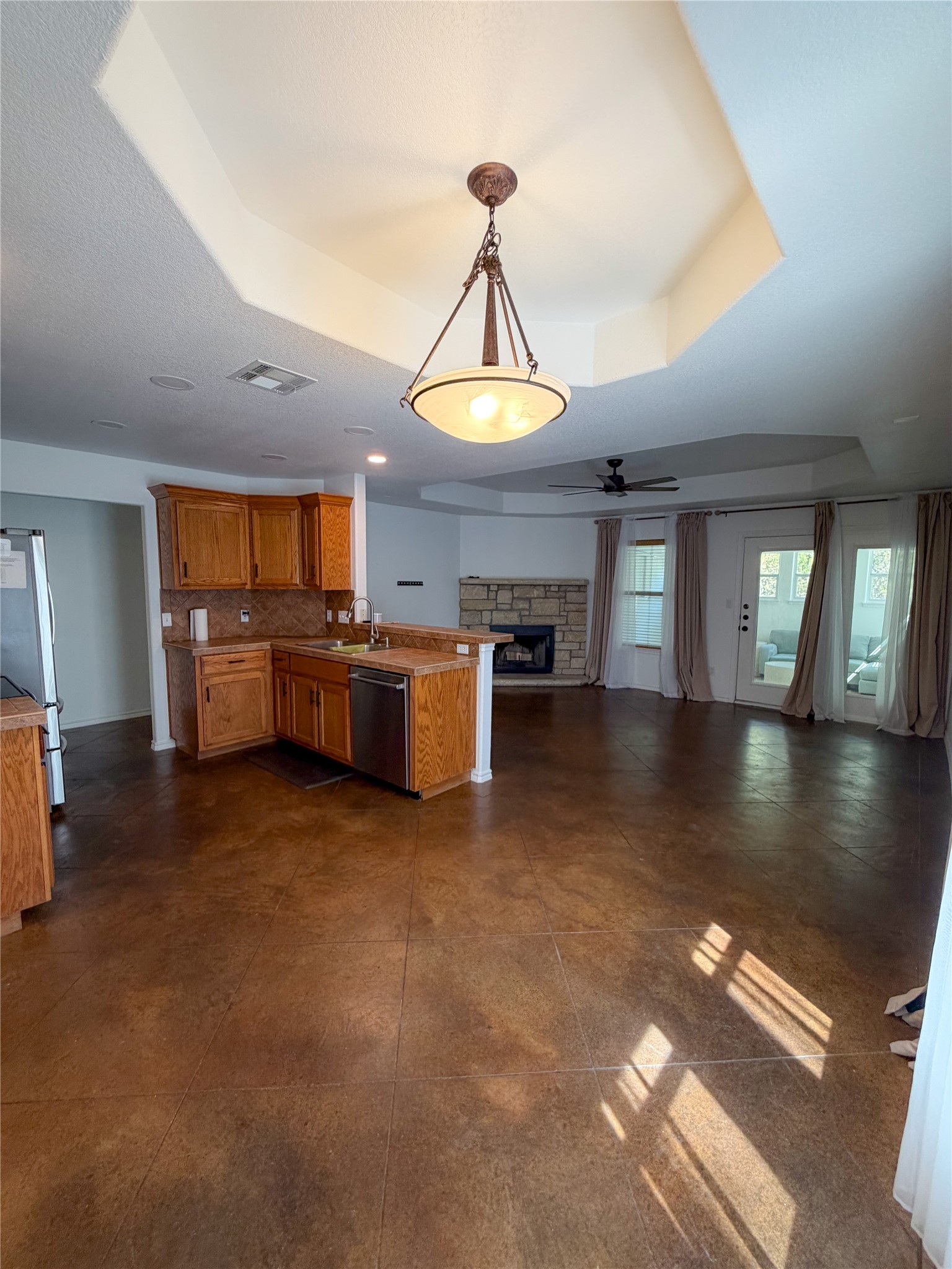 430 Summit Ridge Drive North Point Venture, TX 78645 - Photo 39 of 39 Kitchen with open floor plan, a peninsula, pendant lighting, ceiling fan, and wood finish cabinets
