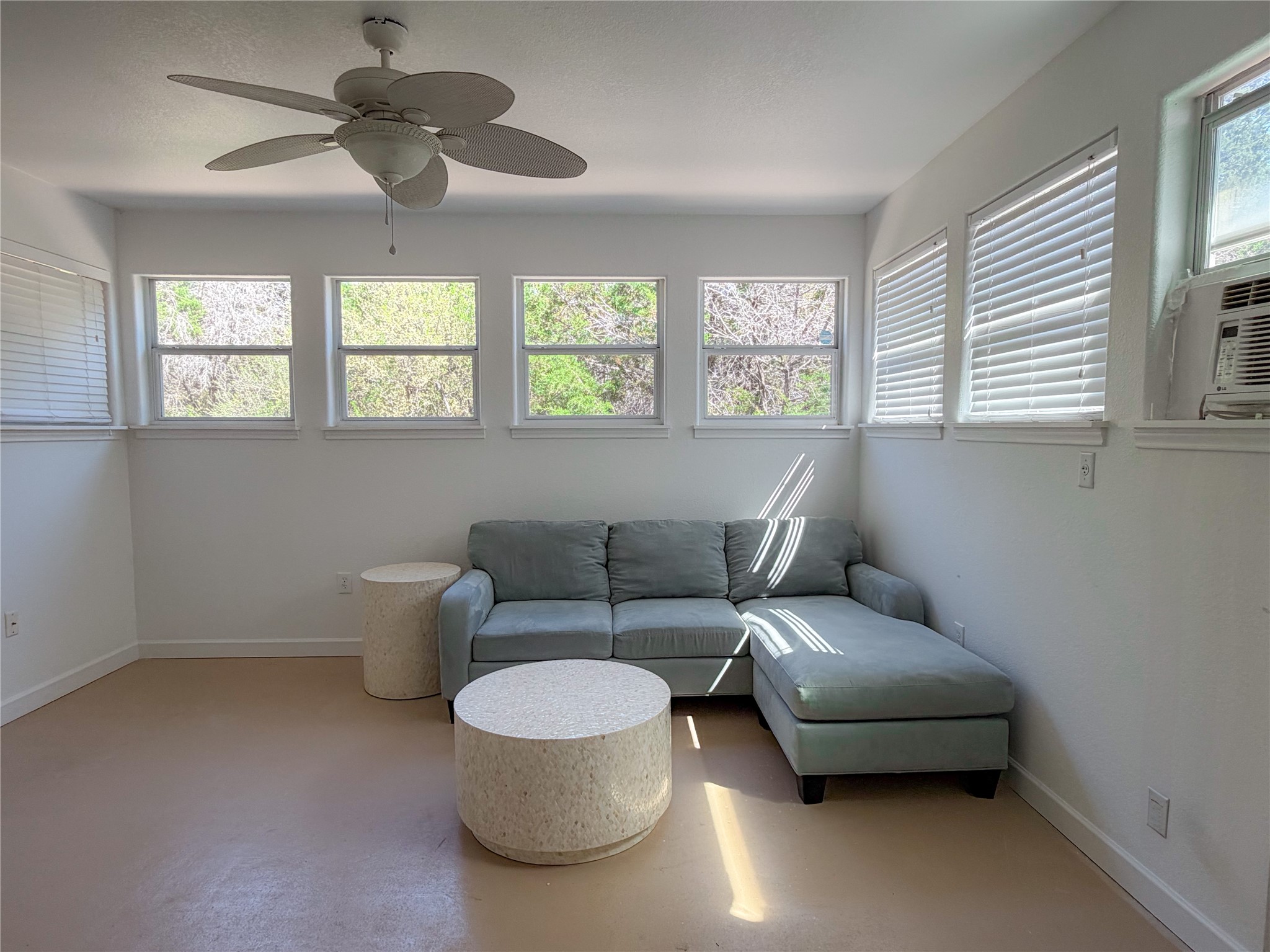 430 Summit Ridge Drive North Point Venture, TX 78645 - Photo 19 of 39 Living room featuring concrete floors, ceiling fan, cooling unit, and healthy amount of natural light