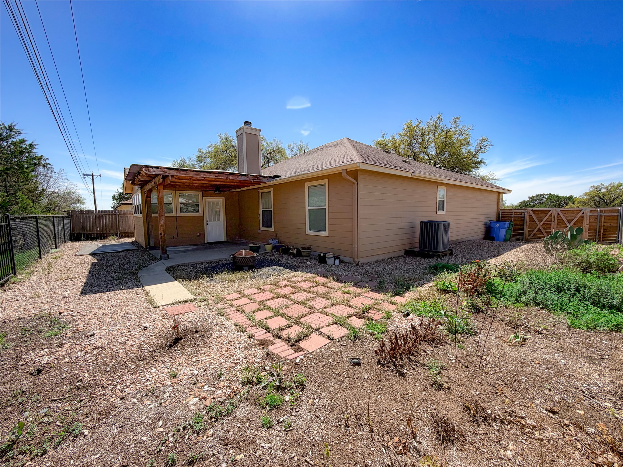 430 Summit Ridge Drive North Point Venture, TX 78645 - Photo 29 of 39 Rear view of property featuring a fenced backyard, a chimney, a patio, and a gate