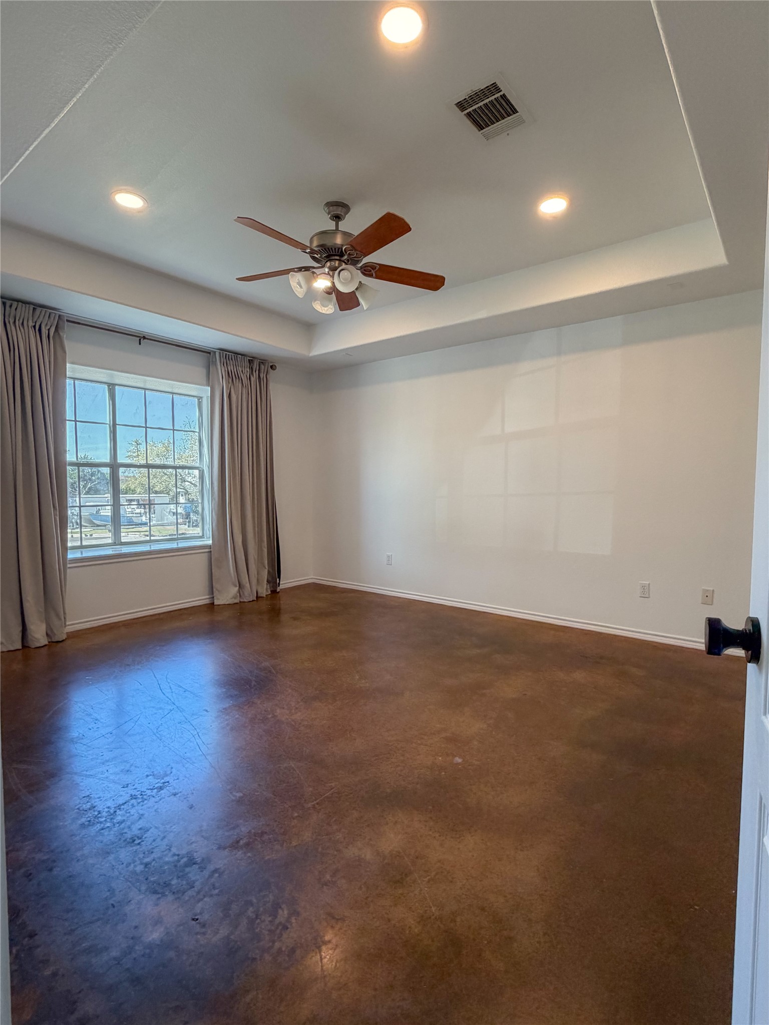 430 Summit Ridge Drive North Point Venture, TX 78645 - Photo 4 of 39 Spare room with concrete floors, a ceiling fan, recessed lighting, and a raised ceiling