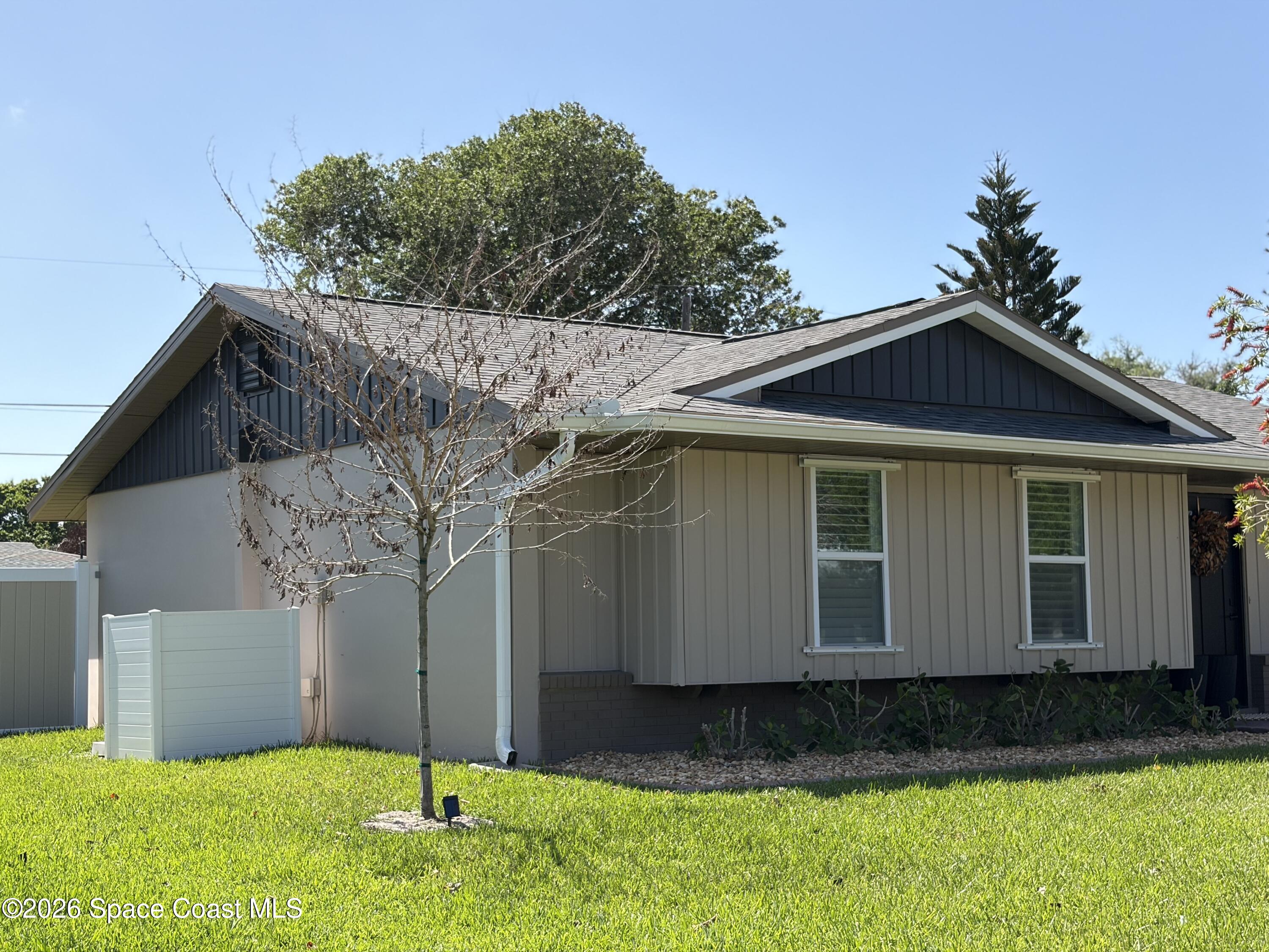 730 Cobblestone Lane Northeast Palm Bay, FL 32905 - Photo 2 of 9 a view of a house with a yard
