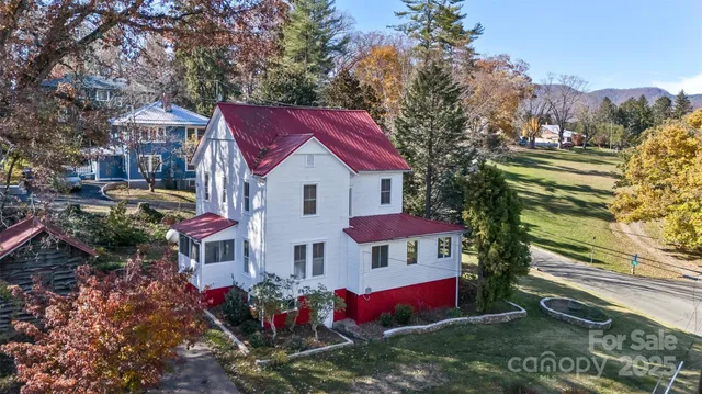 a view of house with outdoor space and sitting area
