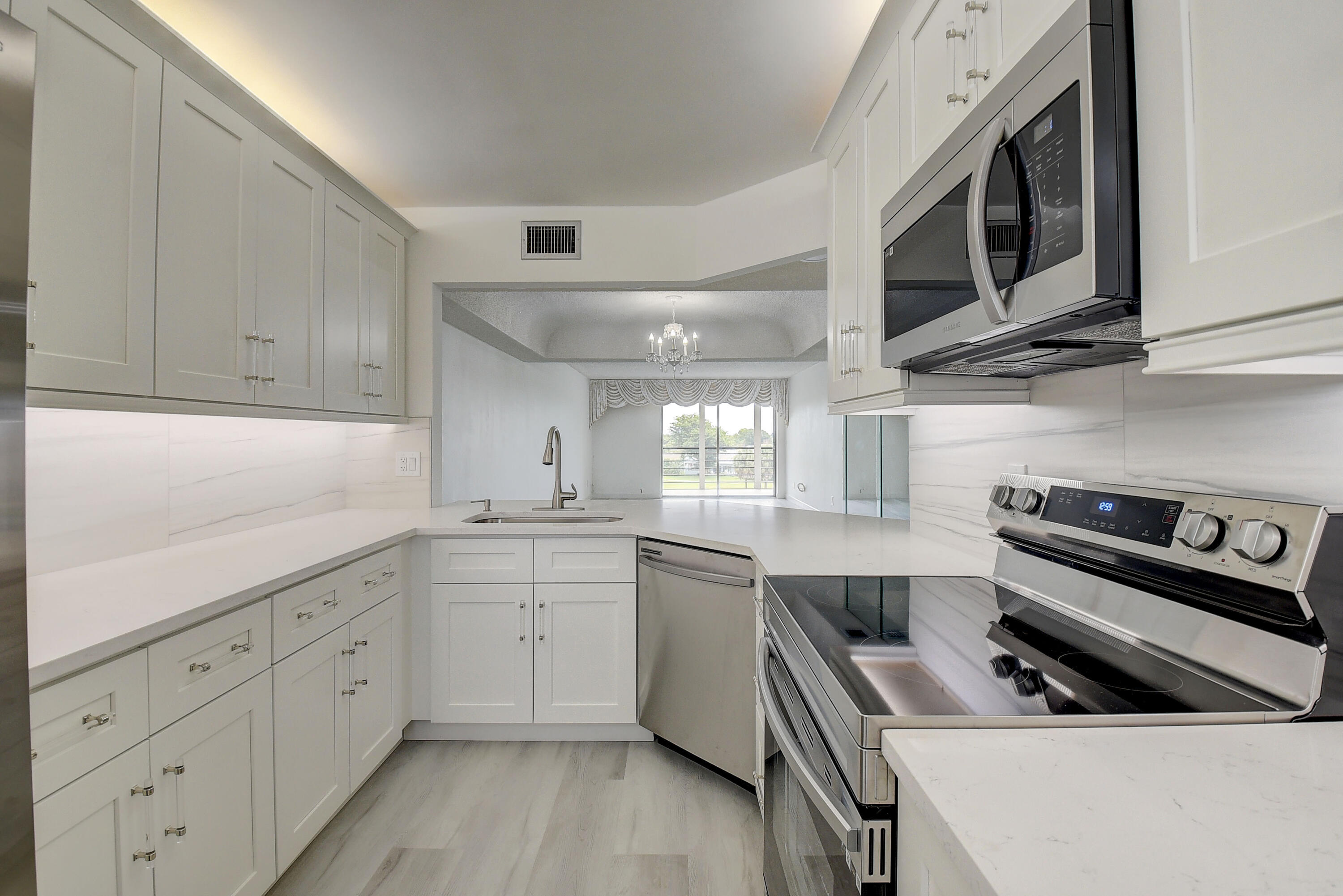a kitchen with a sink stove and cabinets