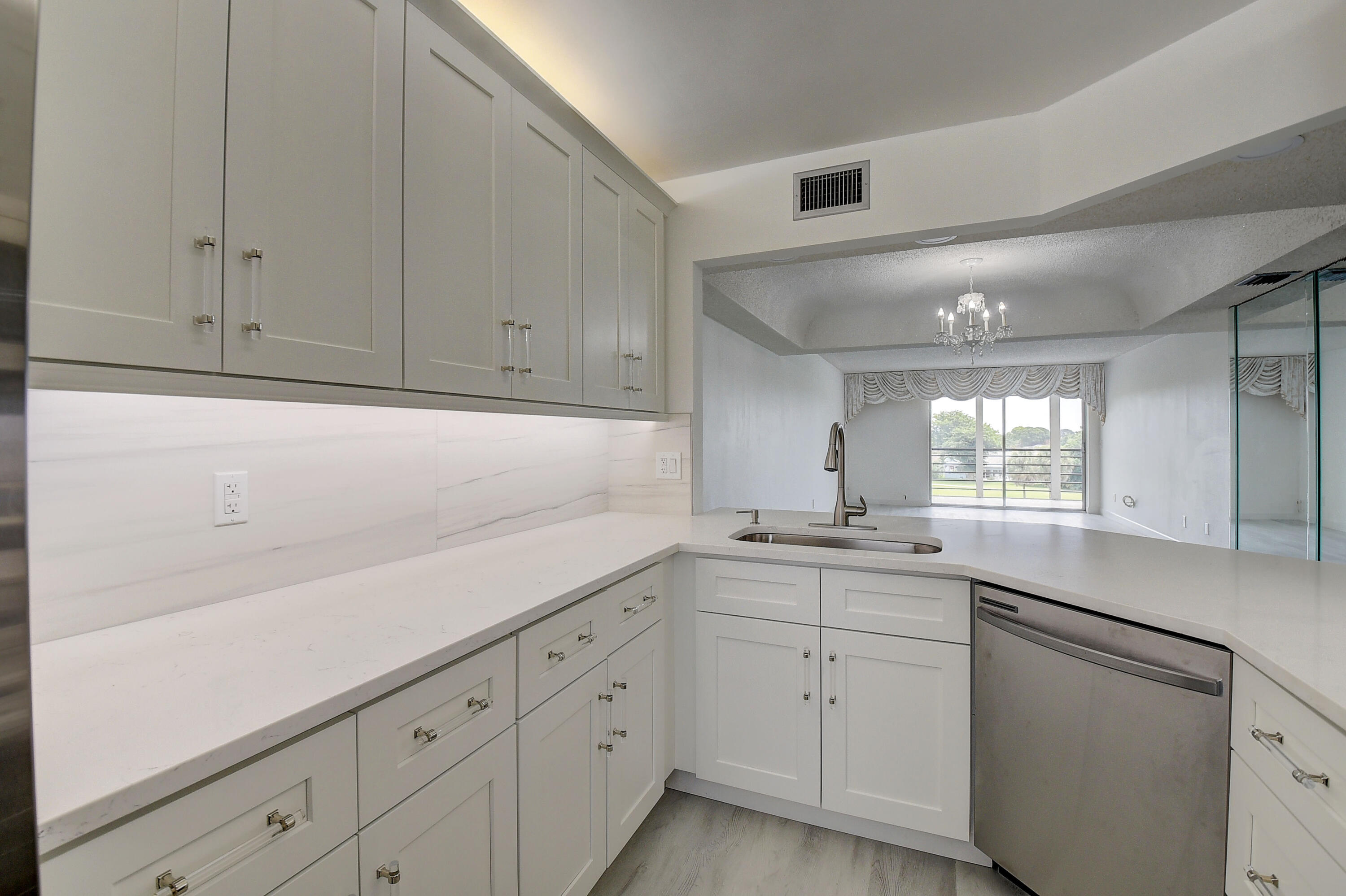 23305 Barwood Lane North, Unit 406 Boca Raton, FL 33428 - Photo 13 of 41 a kitchen with white cabinets