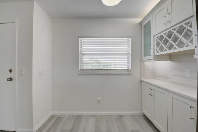 a view of a kitchen that has a sink and a window