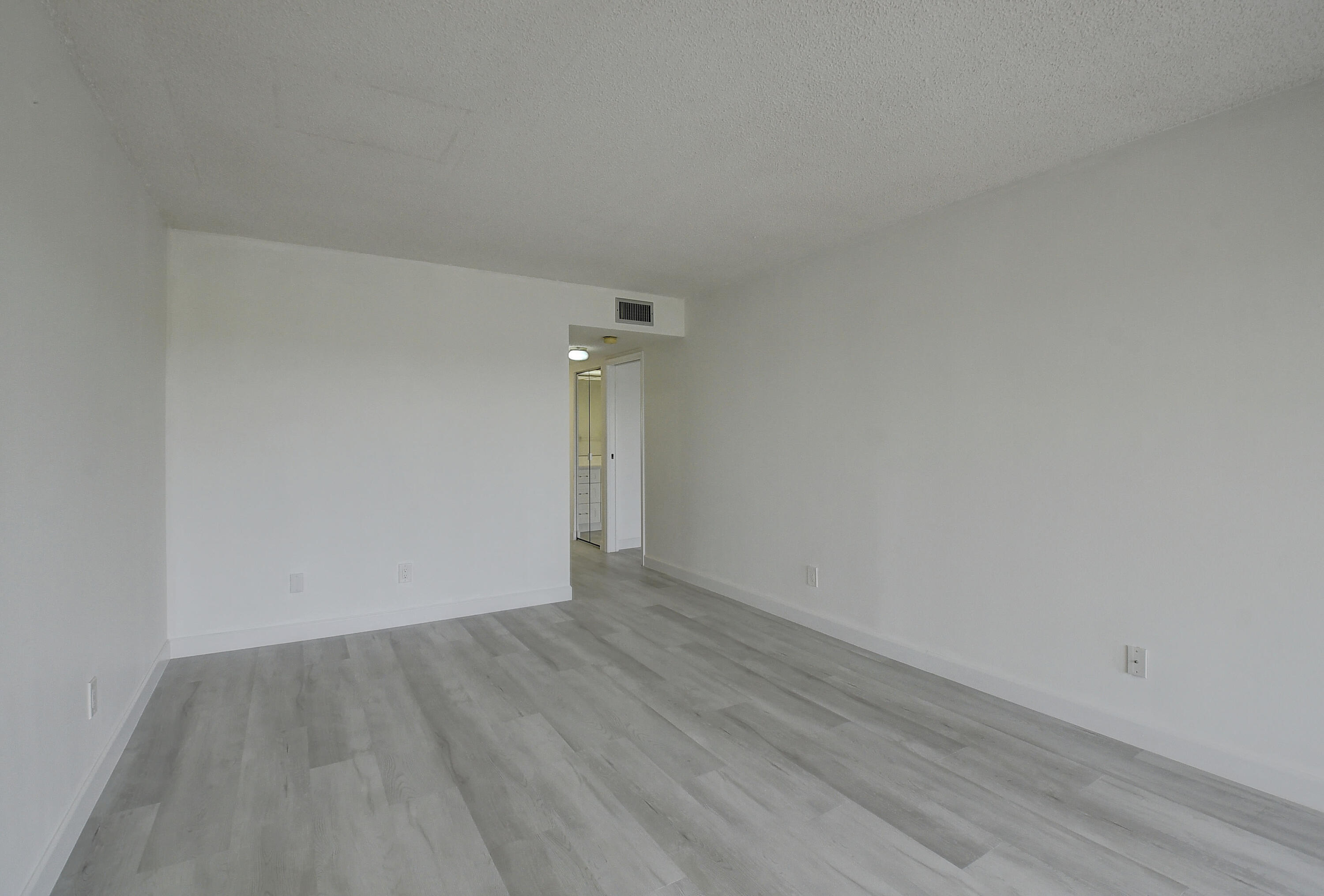 23305 Barwood Lane North, Unit 406 Boca Raton, FL 33428 - Photo 17 of 41 a view of an empty room with wooden floor